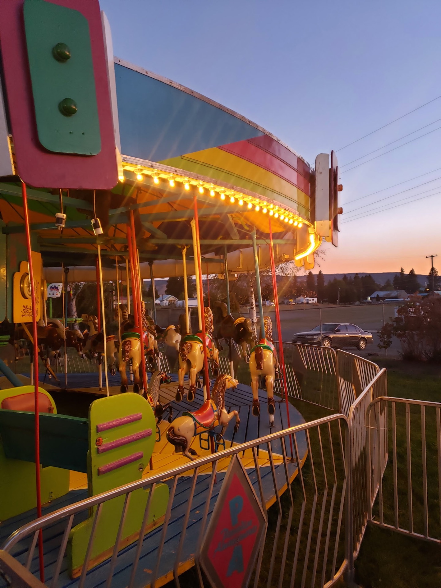 Paradise Amusements carousel spinning in a long-exposure blur of colorful lights at night